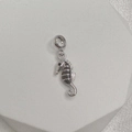 Macro shot of S925 sterling silver seahorse charm with polished finish and hallmark - Style C (Seahorse)