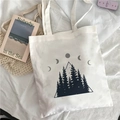 White canvas tote bag featuring artistic black mountain and moon phase graphic prints - Mountain Moon Phases