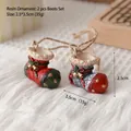 Set of two resin Christmas boot ornaments with gold bells and stars for holiday decor - Christmas Boots (Set of 2)