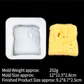 White silicone bread toast mold and textured yellow toast finished piece on black background - 6# Toast Shape/B858
