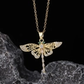 Macro shot of gold dragonfly pendant with white zircons and green gemstone eyes - Style J-Gold Multicolor Gemstone Micro-pave