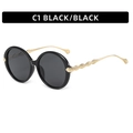 Classic black oversized round sunglasses featuring ornate golden feathered metal temples - Black Frame Grey Lens
