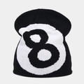 Close-up of black knitted beanie featuring white 8-ball pattern and ribbed texture - White + Black