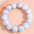 Detail view of large white marble textured round beads on a minimalist elastic bracelet - White Marble Pattern