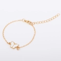 Detail of adjustable gold chain bracelet featuring white enamel butterfly and lobster clasp - White