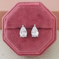 Close-up of pear-shaped zircon earrings in a pink velvet jewelry box showing detail - Pear / Silver