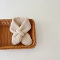 Close-up of beige knitted baby neck warmer, soft wool material, perfect autumn winter detail. - Beige