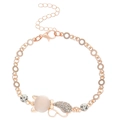 Detailed view of rose gold cat bracelet with white opal and pavé crystals on a white background - Cat Bracelet / Rose Gold (K-1112)