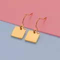 Minimalist geometric gold stainless steel square drop earrings on colorful background - Gold