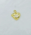 Macro detail of a heart-shaped locket pendant with gold finish and zircon eye design - Eye Heart