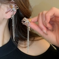 Close-up of sparkling bow tassel earrings with amber and pink teardrop crystals - Silver Ear Clip (54#)