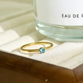 18K gold plated stainless steel slim ring with a round light blue birthstone setting - December-Blue