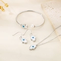 Detailed set of silver Hamsa jewelry with white shell and blue eye charms on a stone - Hamsa Silver 3-Piece Set (KS192835-GC)