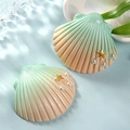 Detail of resin shell charms with gold starfish and white pearls for DIY jewelry crafts - Green and Light Champagne Shell