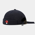 Detail of navy docker hat featuring a small mushroom embroidery and metal buckle - Adjustable / Dark Gray