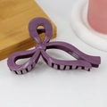 Detail of a purple ribbon bow hair claw clip with smooth glossy finish on a wooden tray - Glossy Deep Purple