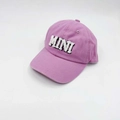 Detailed close-up of white fuzzy MINI embroidery on a lavender cotton baseball cap - Kids MINI / Pink