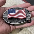 Close-up of 3D embossed US flag belt buckle with intricate scroll patterns - USA Flag