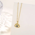 Detailed close-up of golden crown pendant with evil eye and zircons on a white display - Crown Evil Eye / Gold