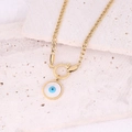 Detail of gold evil eye pendant with blue center on stainless steel chain over beige stone - Round Evil Eye Pendant Link Chain Necklace (8#)