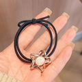 Elastic black hair tie featuring a golden star pendant with white resin inlay detail - Black Star Metal Frame Hair Tie 1Pc