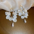Detail view of flower earrings with gold metal frame, white petals and dangling pearls - Gold-White (Style 3)