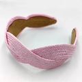 Close-up of pink woven raffia headband showing intricate braided texture and detail - Pink