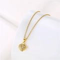Detail of golden fish pendant necklace with clear zircon stones on a white background - Hollow Fish / Gold