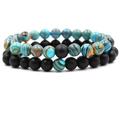 Detail of 8mm volcanic stone and marble beads on elastic bracelets in a 2-piece set - Matte Black + Blue Malachite