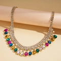 Close-up of geometric square pendant with colorful rhinestones and gold tassel detail - Gold