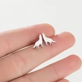 Polished silver screaming wolf stud earrings shown on finger for size reference - Steel