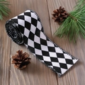 Classic black and white checkered Christmas ribbon roll on rustic wooden background - Black and White Argyle
