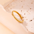 Elegant gold twisted rope open ring made of titanium steel displayed on a stone surface - Twisted Rope