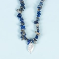 Lapis lazuli stone necklace with irregular baroque pearl pendant on light blue background - Lapis Lazuli Pearl