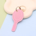 Detail of pink faux leather tennis racket keychain with gold metal ring and chain - Keychain style / Pink Tennis Racket