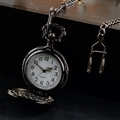 Vintage mosque quartz pocket watch with engraved lid and chain on dark background - Black