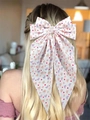 Detailed back view of a white bow hair clip with colorful heart patterns on long hair - Streamer Clip Vintage Printed
