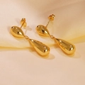 Polished gold-plated teardrop dangle earrings on elegant champagne silk fabric background - Gold Double Teardrop Dangle