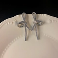 Elegant silver bow earrings with sparkling micro-pave crystals on a white ceramic tray - 21#E5273 Silver Pin-Silver
