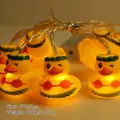 Hula duck LED string lights with yellow rubber ducks in grass skirts and bikinis - Hula Duck (1.8m 10 LEDs - 2AA Constant Light Battery Box)