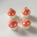 Set of four orange resin mushroom charms with white dots and silver hanging loops - Orange