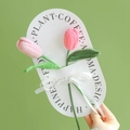 Handmade crochet pink tulip bouquet on white card with decorative ribbon detail - Closed Tulip (Light Pink + Dark Pink)