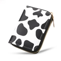 Slim accordion card holder with cow print pattern and golden zipper closure - Cow