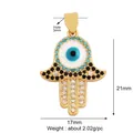 Macro shot of Hamsa Hand jewelry pendant with dimensions 21x17mm and blue evil eye detail - M599348-turquoise / Turquoise