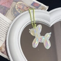 Close-up of holographic balloon dog keychain on heart mirror with green bead chain - Iridescent Light Yellow