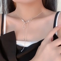 Silver bow necklace with white pearls on model's neck for a trendy feminine look - 74#X4269 (Bowknot Artificial Pearl Necklace)