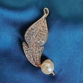 Macro shot of rose gold leaf brooch featuring white rhinestones and a focal pearl - Fallen Leaf Brooch