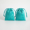 Two tiffany blue faux suede drawstring jewelry pouches set against a white background - Tiffany Blue