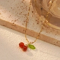 Golden cherry pendant necklace with red berries and green leaf on beige stone - Single Necklace / Red