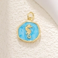 Detailed close-up of golden seahorse pendant with sparkling blue enamel and shiny finish - Small Seahorse